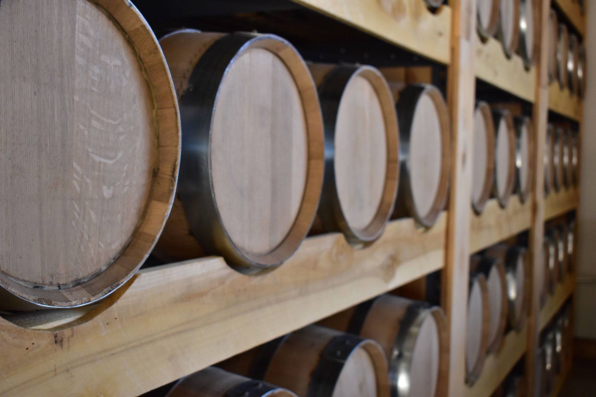 Oak barrels aging at the Rod & Hammer’s distillery